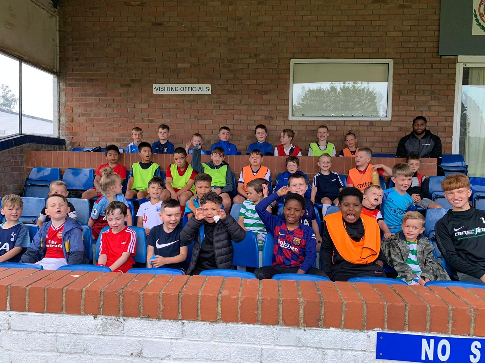Young people at one of our holiday camps sitting together in the stand